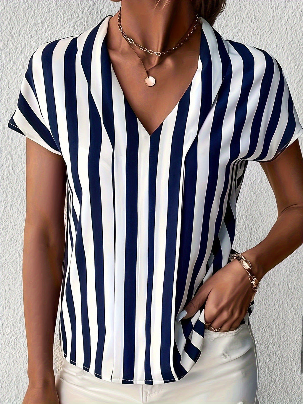 Women's blouse in an elegant striped design with a modern V-neck and short sleeves, size [size missing]