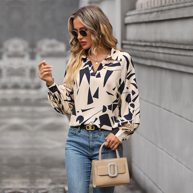 Women's blouse with a striking graphic design and voluminous sleeves, size S