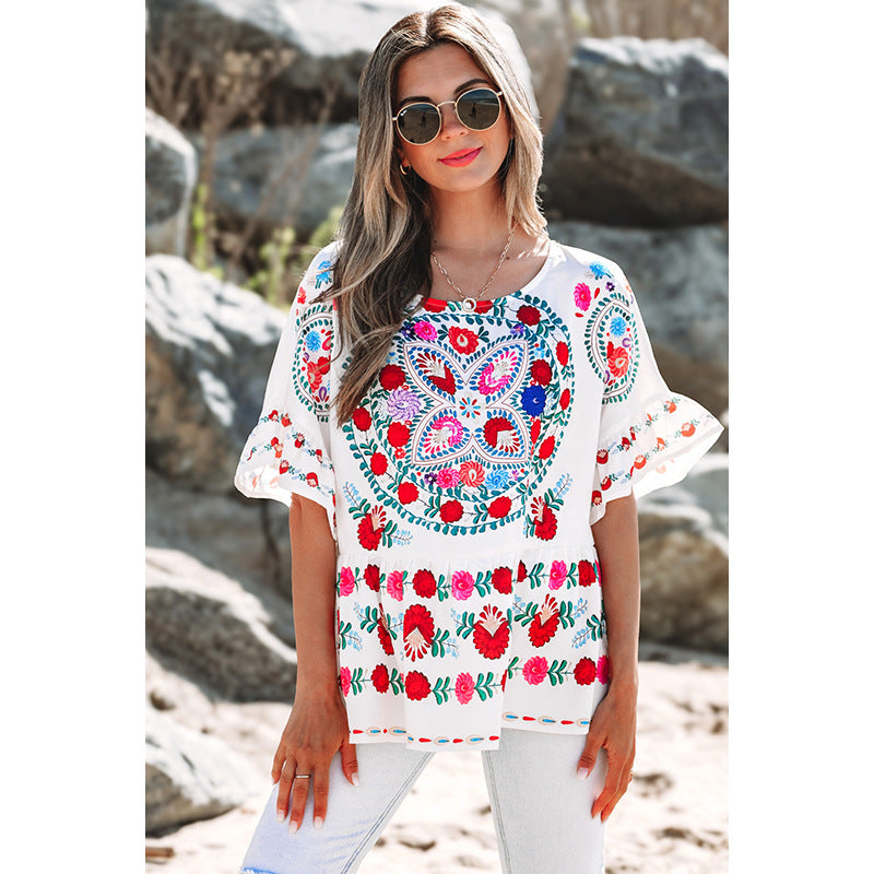 Women's embroidered blouse top with voluminous sleeves and floral motifs, size [size missing]
