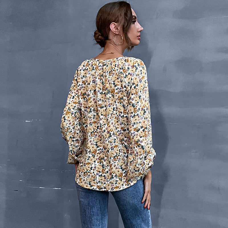 Women's blouse with floral design and elegant puff sleeves, size