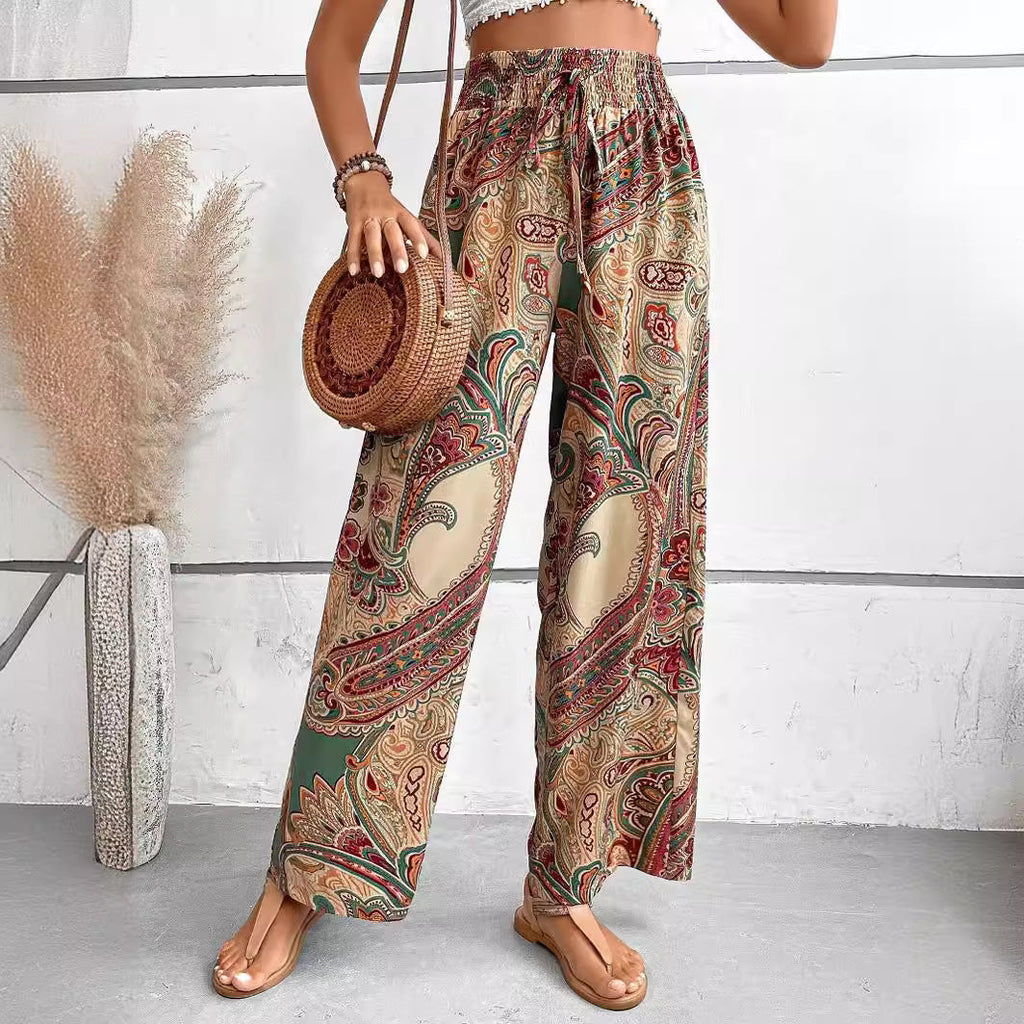 Women's wide-leg palazzo trousers with elasticated waistband and elegant paisley pattern, size S