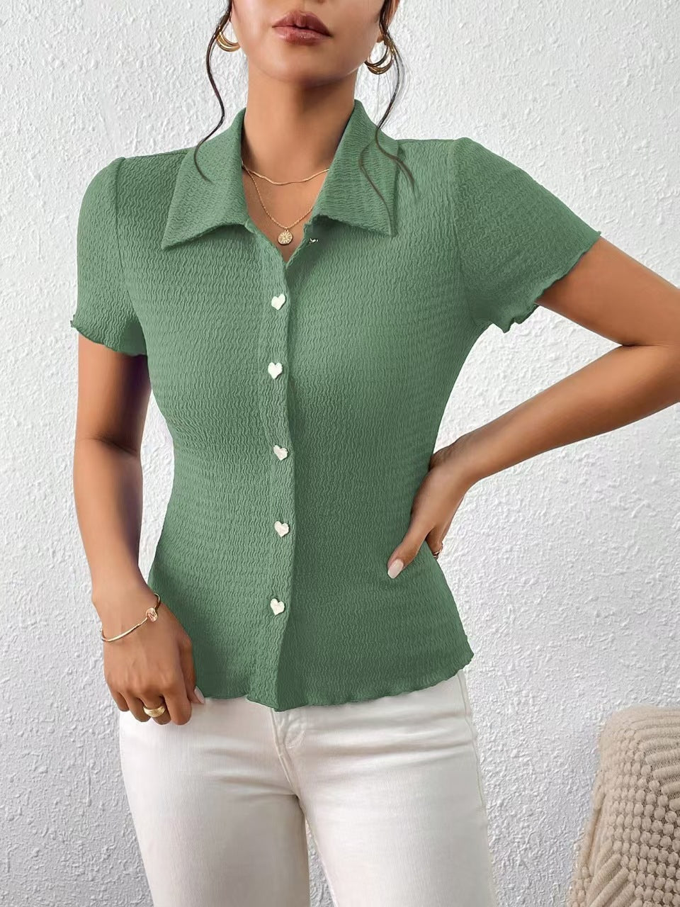 Women's short-sleeved blouse with a structured design and heart-shaped buttons, size [size missing]
