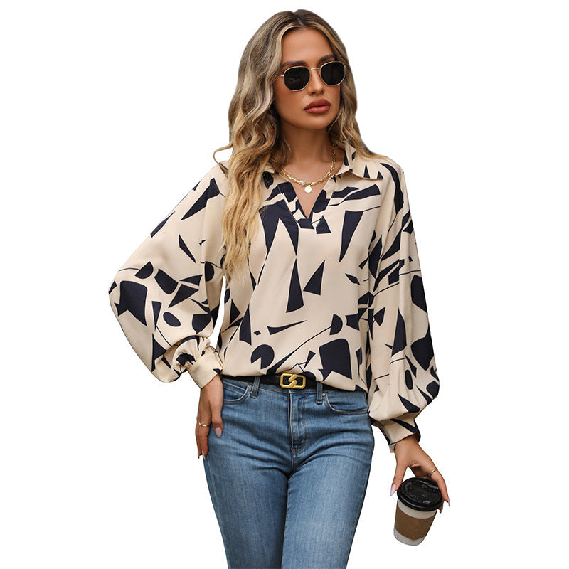Women's blouse with a striking graphic design and voluminous sleeves, size S