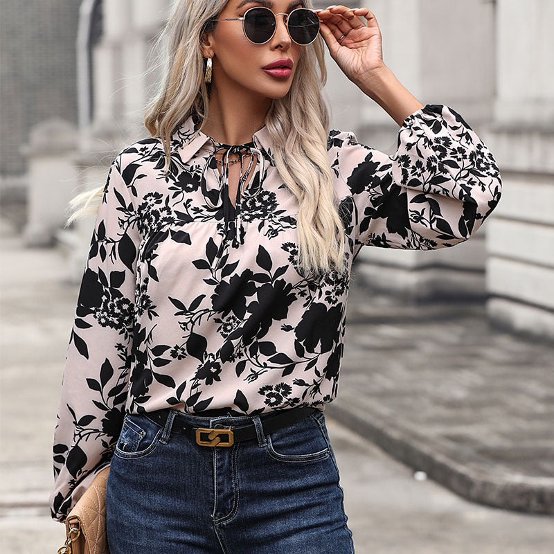 Women's blouse with elegant ruffle details and playful floral pattern, size