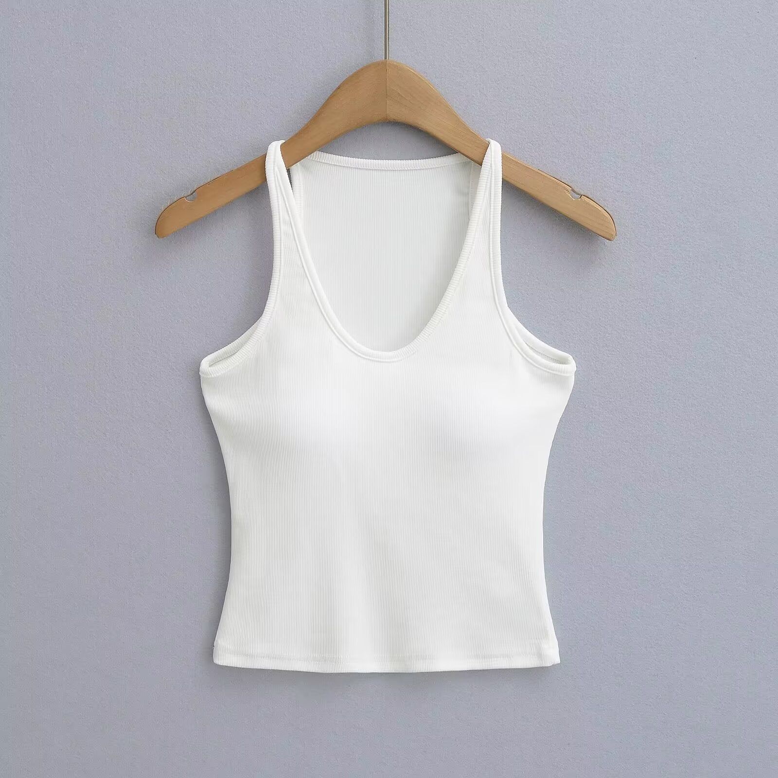 Women's sleeveless sports top with deep U-neck and elastic material, size S
