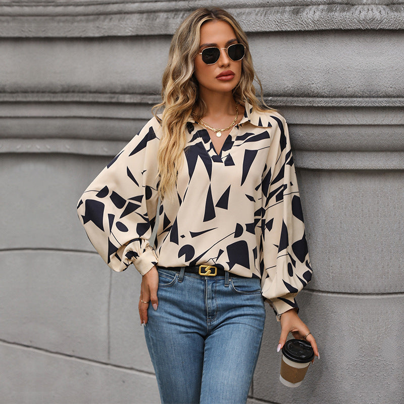 Women's blouse with a striking graphic design and voluminous sleeves, size S