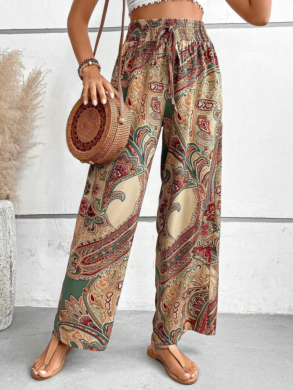 Women's wide-leg palazzo trousers with elasticated waistband and elegant paisley pattern, size S