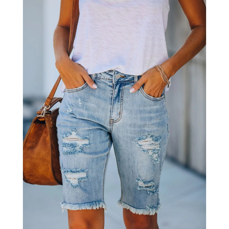 Women's distressed denim shorts in a relaxed fit with frayed hems, size [size missing]