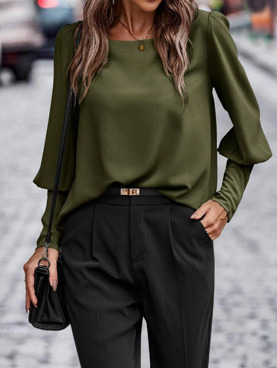 Women's blouse with elegant puff sleeves and flowing fabric, size S