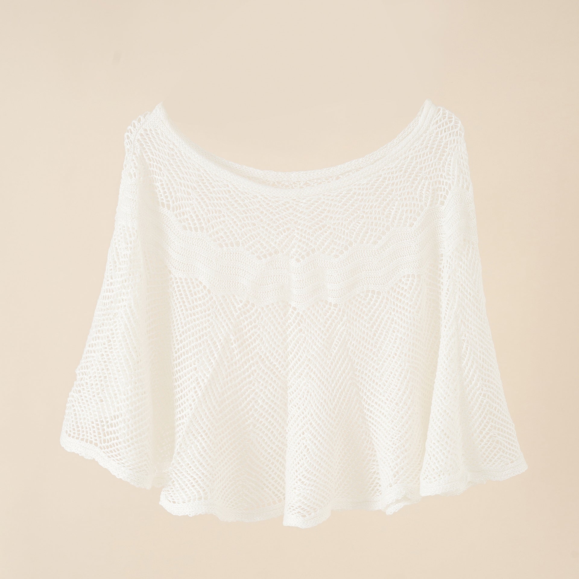 Women's airy knitted poncho in a modern design, size