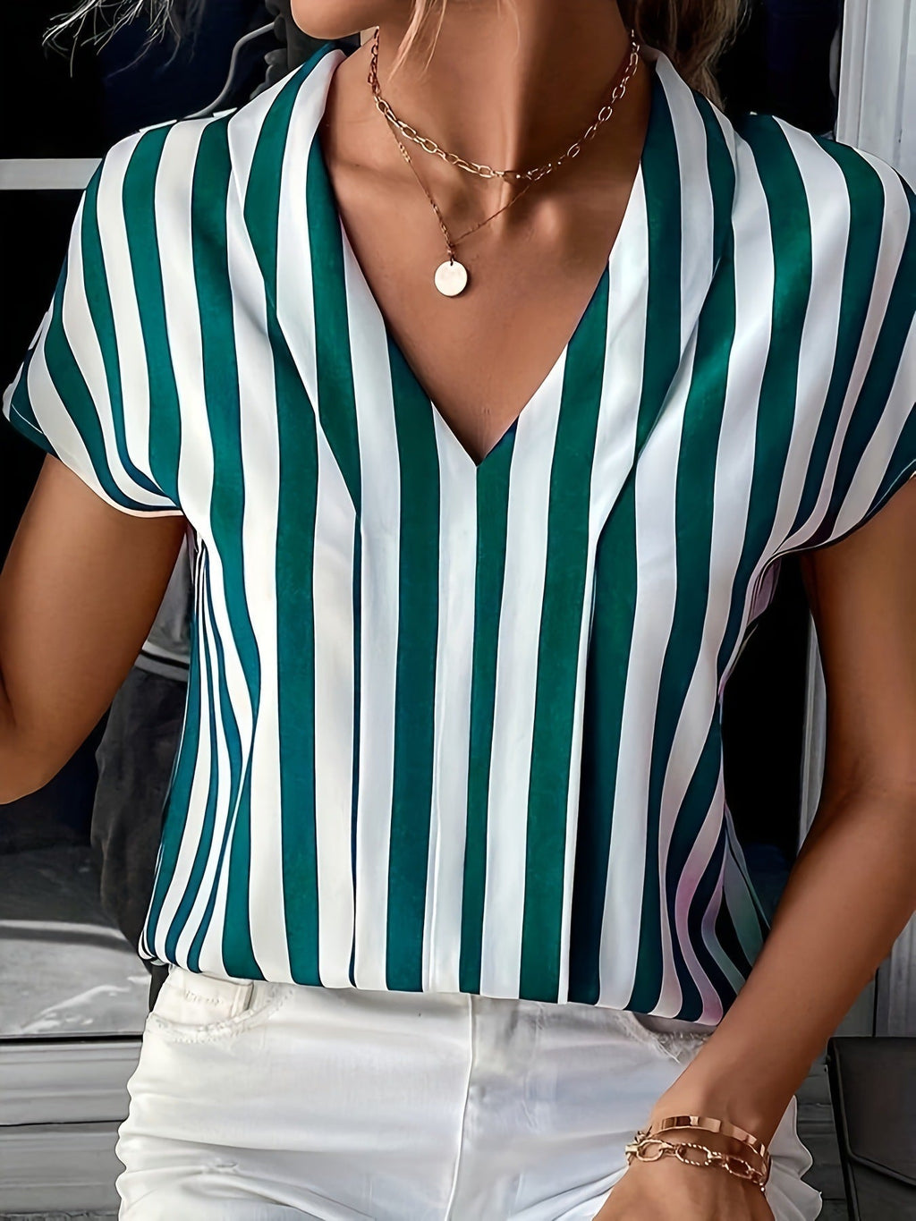 Women's blouse in an elegant striped design with a modern V-neck and short sleeves, size [size missing]