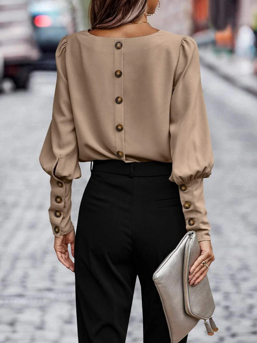 Women's blouse with elegant puff sleeves and flowing fabric, size S