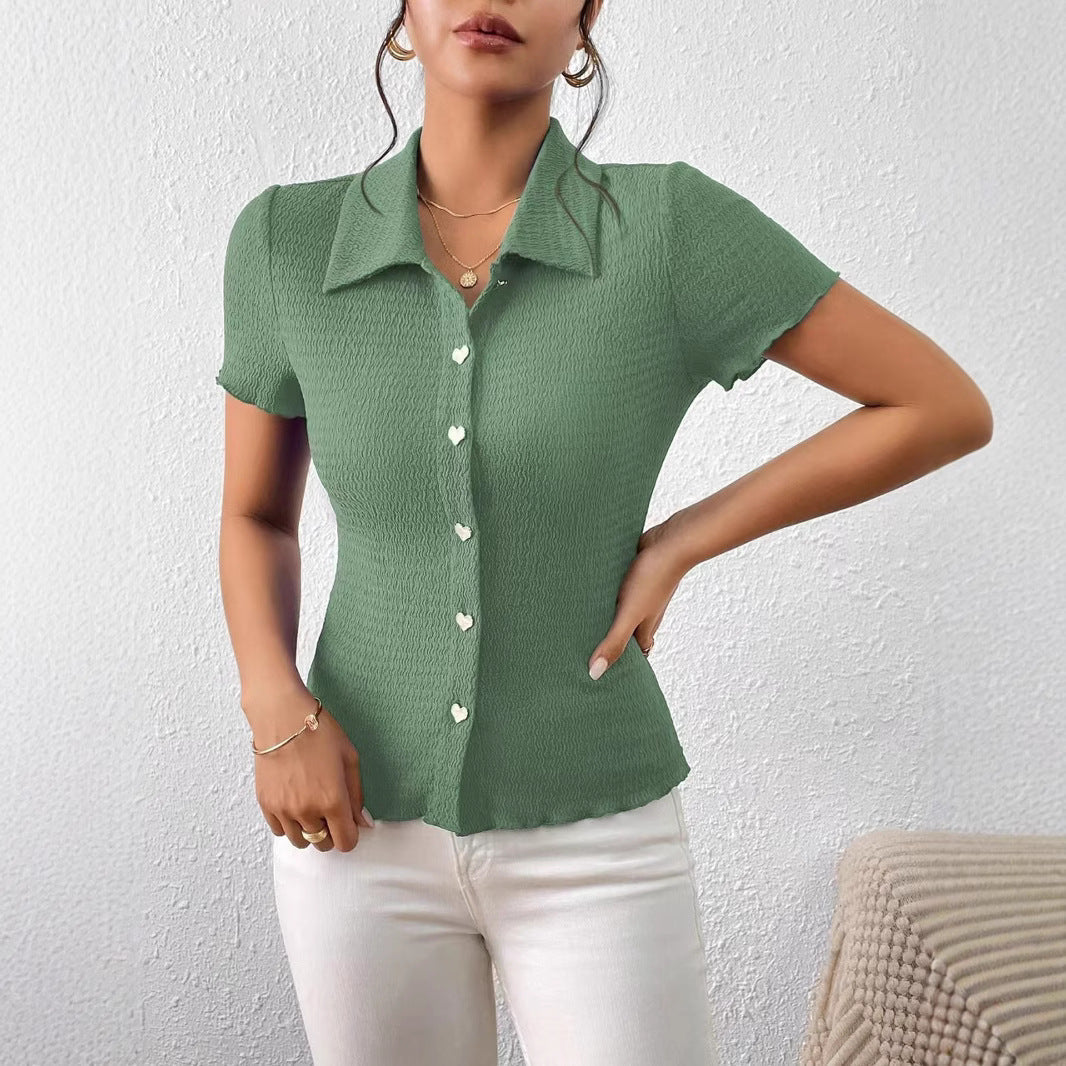 Women's short-sleeved blouse with a structured design and heart-shaped buttons, size [size missing]