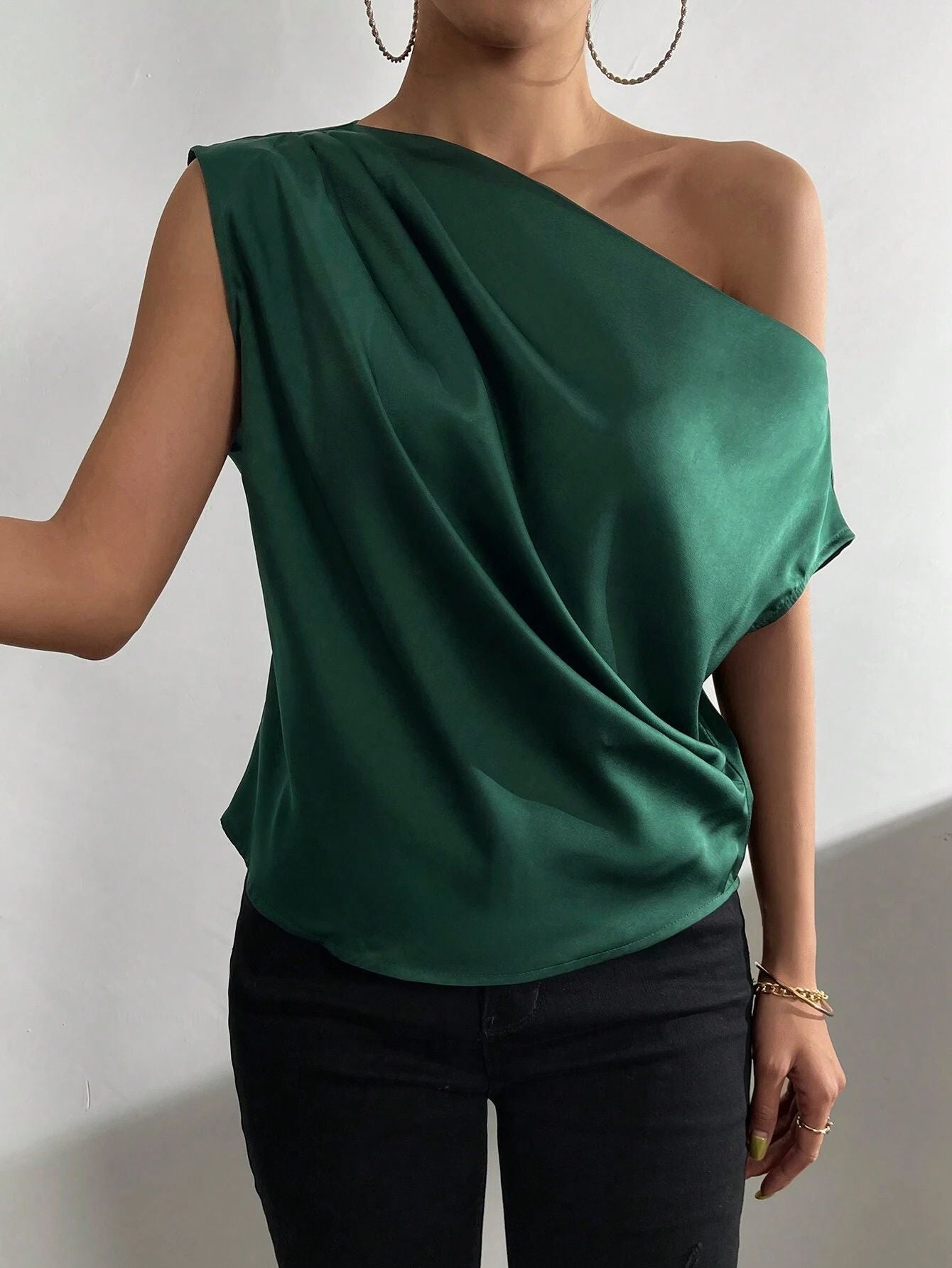 Women's asymmetrical top with draping and elegant cut, size