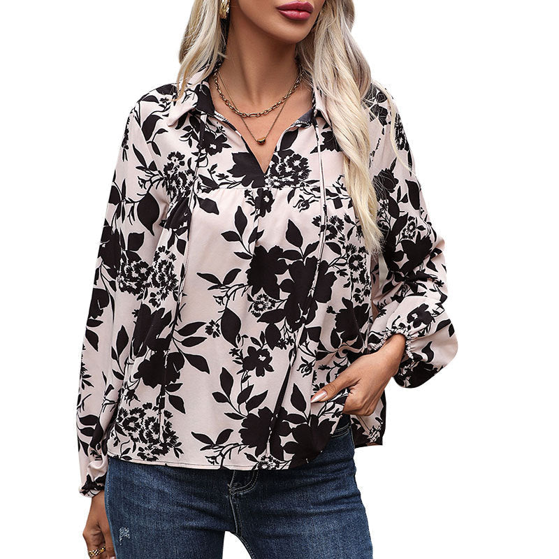Women's blouse with elegant ruffle details and playful floral pattern, size