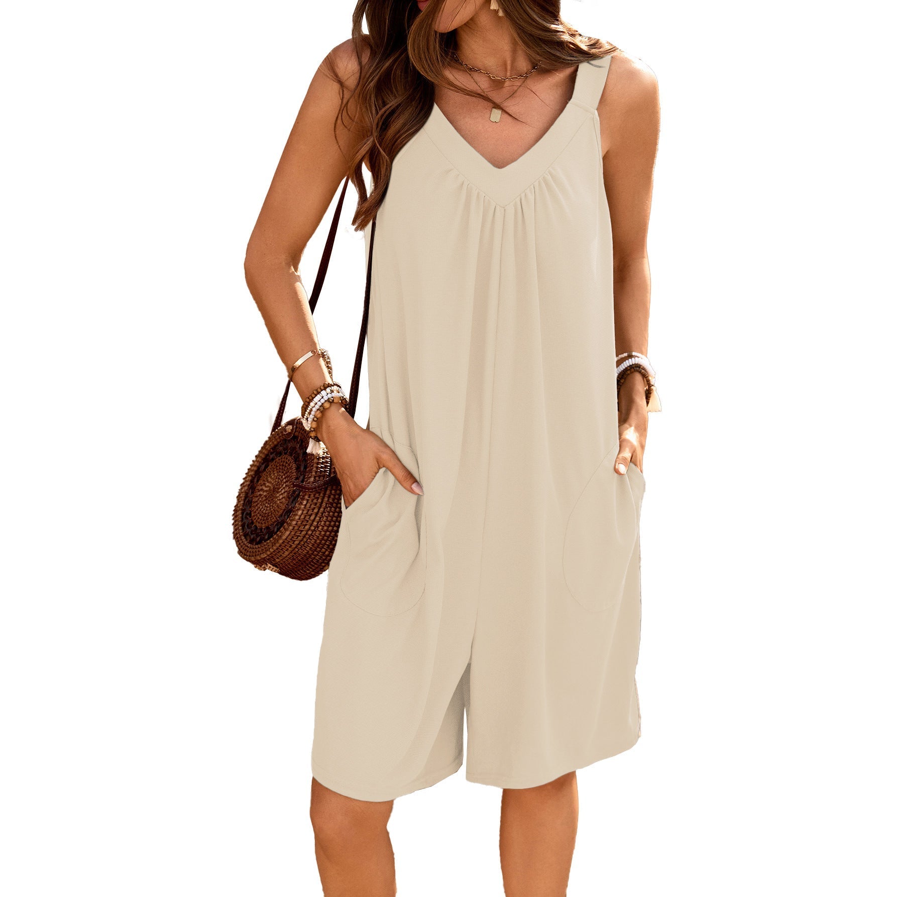 Women's sleeveless jumpsuit with deep V-neck and practical pockets, size S