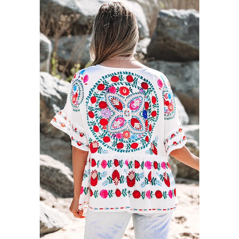 Women's embroidered blouse top with voluminous sleeves and floral motifs, size [size missing]