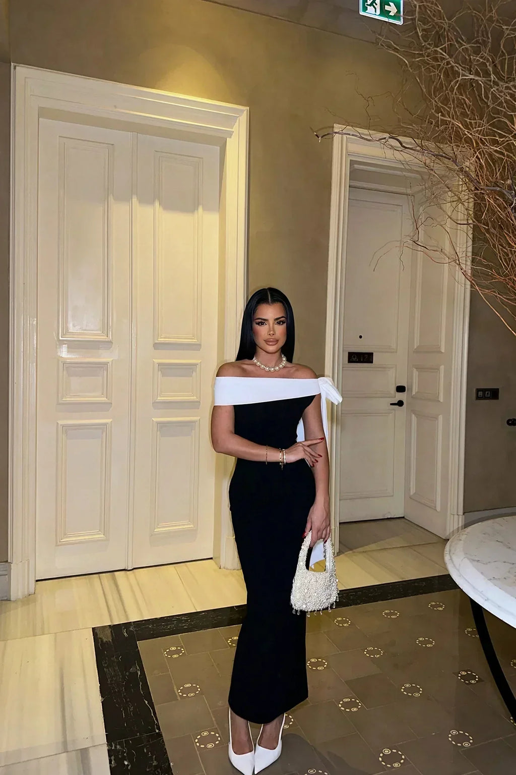 Valenzora | Elegant off-shoulder midi dress in black with white bow detail